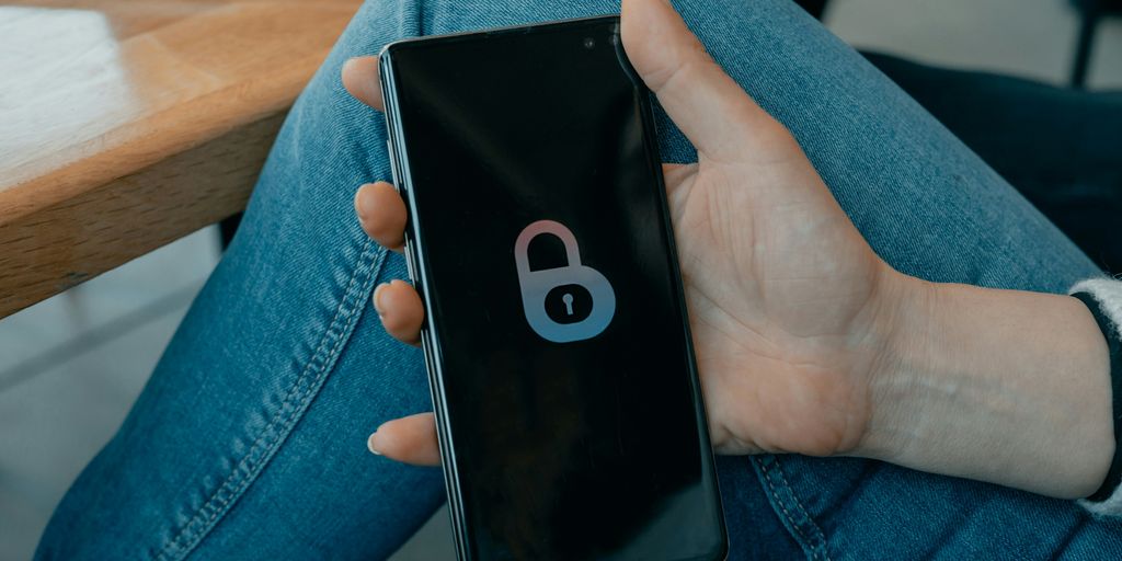 black and white smartphone on persons hand