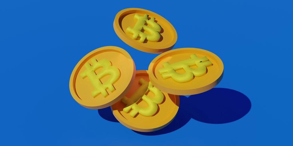 three gold bitcoins sitting on top of each other