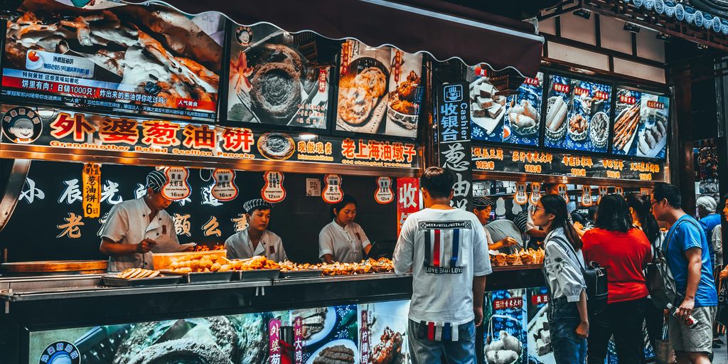 group of people buying food on food stall